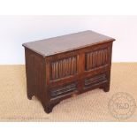 A 1920's small oak coffer, of 17th century style, with linen fold carving,