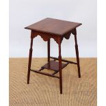 An Edwardian mahogany two tier occasional table, on turned legs,