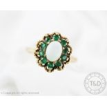 An opal and emerald oval cluster ring, Birmingham 1975,