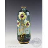 A French Art Nouveau glass bottle vase, externally enamelled with floral sprays and flower heads,