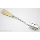 A William IV silver stilton scoop, London 1834 (makers mark rubbed), with faceted ivory handle, 24.