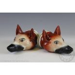 A pair of 19th century Staffordshire pottery fox mask stirrup cups, each modelled with ears raised,