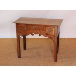 A George III and later oak low boy, with three plank top above three drawers, with serpentine apron,