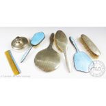 A selection of seven silver and silver and enamel dressing table brushes, mirrors,