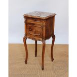 A late 19th century French walnut beside pot cupboard, of serpentine form,