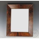 An early 19th century rectangular cushion frame wall mirror, possibly laburnum,