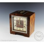 A 1930's walnut quarter chiming mantel clock,