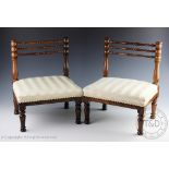 A pair of 19th century rosewood apprentice chairs, of diminutive size, with turned three bar backs,