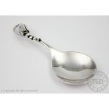 A Georg Jensen Blossom pattern caddy spoon, import mark for London 1972, of plain polished design,