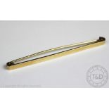 A yellow gold stock pin, of plain polished form, stamped '9ct' verso, 7cm wide, weight 4.
