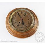 An early 20th century oak wall time piece, copper dial with Arabic numerals and subsidiary seconds,
