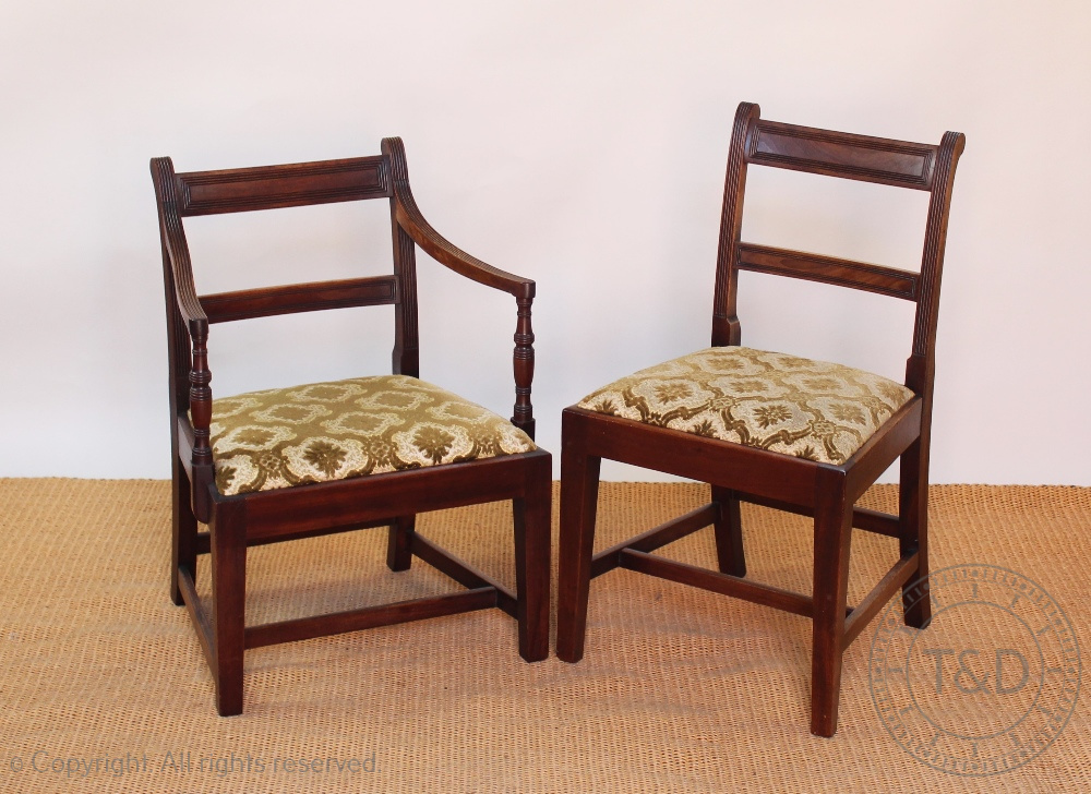 A set of six early 19th century mahogany dining chairs, with reeded bar backs and drop in seats,