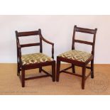 A set of six early 19th century mahogany dining chairs, with reeded bar backs and drop in seats,