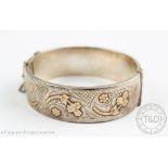 A silver and gold hinged bangle, Deakin and Francis Birmingham early 20th century,