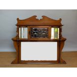 A late Victorian Art and Crafts golden oak overmantle mirror, in the manner of Liberty & Co,