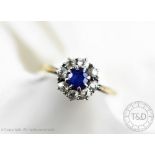 An untested sapphire and diamond circular cluster ring,