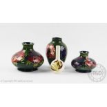 Four pieces of Moorcroft pottery; a poppy pattern vase, 11cm high, an anemone pattern squat vase,