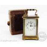 An early 20th century brass carriage time piece,