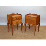 A pair of 18th century style birch bedside tables, with two drawers, on cabriole legs,