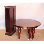 A Victorian mahogany extending dining table, with four spare leaves,