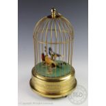 A West German gilt brass singing bird automaton, with three birds under a dome,