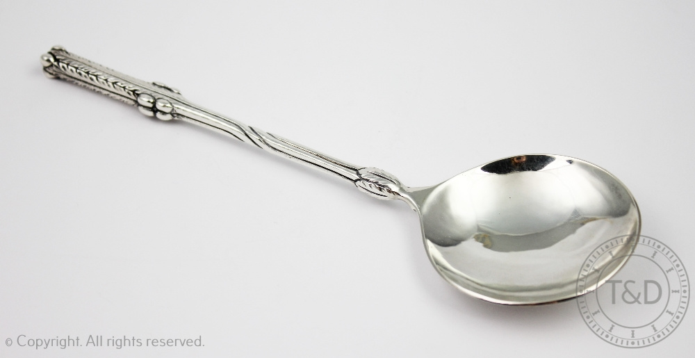 An Edward VIII Liberty & Co silver spoon, the Arts and Crafts spoon with foliate stem,