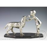 An Art Deco style chromed figural group, modelled as a young girl training a retriever,
