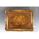 An early 20th century Dutch inlaid walnut serpentine tray, decorated with flowers,