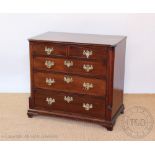 A late George III and later mahogany chest, with two short and three graduated long drawers,