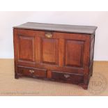 A George III oak mule chest, with hinged top and two drawers, on later bracket feet,