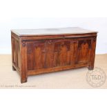 An 18th century oak coffer with later applied detailing, with arched front, on stile feet,