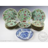 Three famille rose plates, decorated with flowers and insects against a celadon ground,