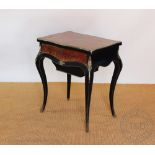 A 19th century French Boulle work worktable, brass inlaid tortoiseshell, of serpentine form,