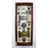 A collection of Trinidad and Tobago police uniform buckles, badges, initials and stars,
