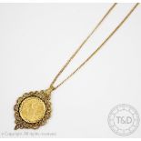 A George V gold half sovereign dated 1913, within 9ct gold surround and attached chain,