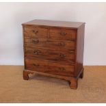 A late George III mahogany chest, with two short and three graduated long drawers, on bracket feet,