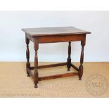 An 18th century oak side table, with two plank top, on turned and block legs,