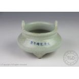 A Chinese porcelain Guan type craquelure glazed tripod censer,