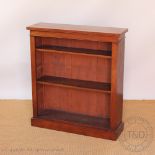 A Victorian walnut dwarf open bookcase, with two adjustable shelves,