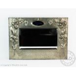 An Art Nouveau pewter mounted rectangular wall mirror,