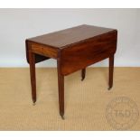 An early 19th century mahogany Pembroke table, with drawer on reeded and tapered square legs,