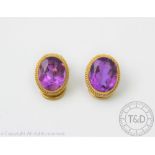 A pair of amethyst set earrings within 9ct gold collet settings and clip fittings and a pair of