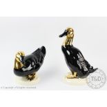 Two Goebels models of ducks, in black and gold, tallest 26.