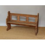 A pitch pine pew, with three section open back, on standard end supports,