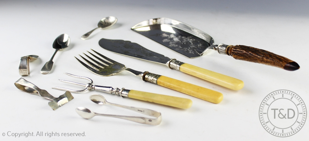 An assortment of silver and silver plated cutlery to include a pair of sugar nips,