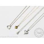 A selection of pendants, to include; two heart shaped pendants and chains in 9ct white gold,