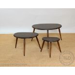 A nest of three Ercol dark wood pebble tables, all with labels to the underside,