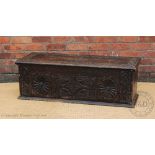 A Victorian carved and stained oak coffer,