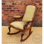 A Victorian mahogany rocking chair,