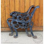 A pair of Coalbrookdale style cast iron bench ends, with lions head arms, on scroll legs,